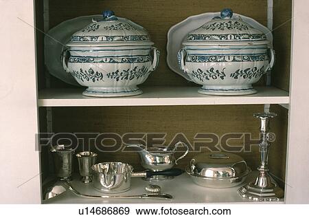 Close-up of antique tureens and silver jugs and dishes on white shelves View Large Photo Image Stock Photo - Close-up of antique tureens and silver jugs and dishes on white shelves. Fotosearch