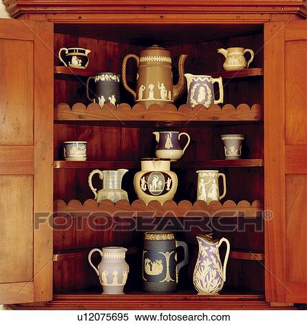 Stock Photography - Close-up of antique Wedgewood jugs on dresser shelves. Fotosearch