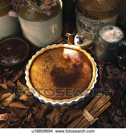 Picture - Close-up of apple flan and glass of ale. Fotosearch