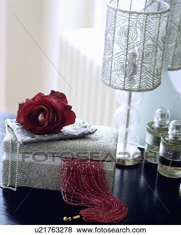 Stock Photo - Close-up of beaded lampshade and box with red rose. Fotosearch