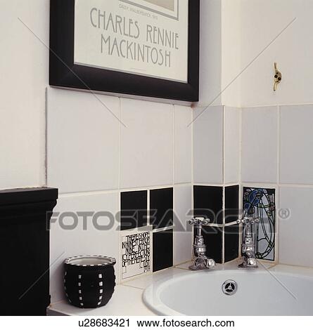 Stock Image - Close-up of black+white Charles Rennie Mackintosh style tiles above corner-set basin. Fotosearch