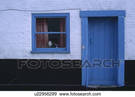 Stock Photo - Close up of blue front door and windowframe on cottage. Fotosearch