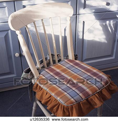 Close-up of blue+brown checked cushion on white wooden chair View Large Photo Image Stock Photograph - Close-up of blue+brown checked cushion on white wooden chair. Fotosearch
