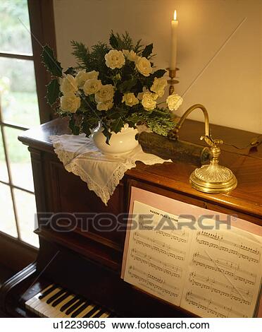 Close-up of candle and roses in vase on piano View Large Photo Image Stock Photography - Close-up of candle and roses in vase on piano. Fotosearch