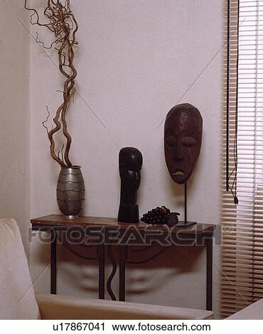 Close-up of carved African masks on wooden table View Large Photo Image Stock Image - Close-up of carved African masks on wooden table. Fotosearch