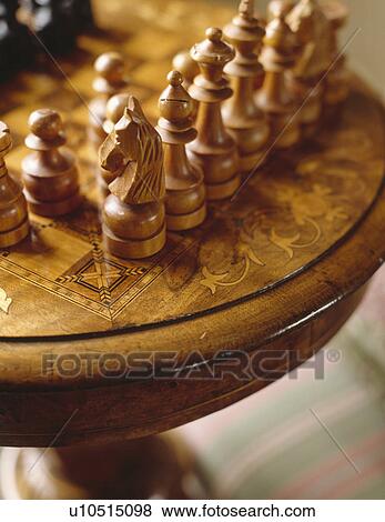 Stock Photo - Close-up of chess pieces on antique table. Fotosearch