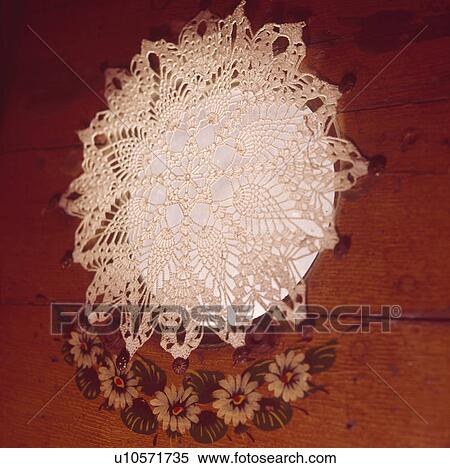 Stock Photography - Close up of circular lace curtain on porthole of narrow boat. Fotosearch