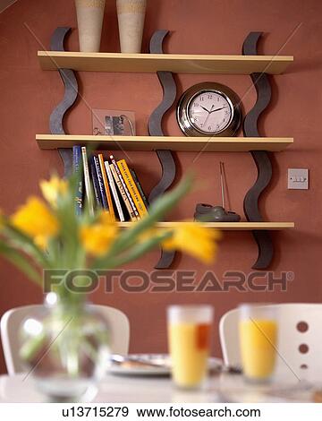 Close-up of clock on modern shelves in terracotta dining room View Large Photo Image Stock Photo - Close-up of clock on modern shelves in terracotta dining room. Fotosearch