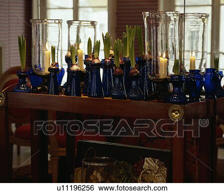 Close-up of collection of blue glass bulb vases and lighted candles View Large Photo Image Stock Photograph - Close-up of collection of blue glass bulb vases and lighted candles. Fotosearch