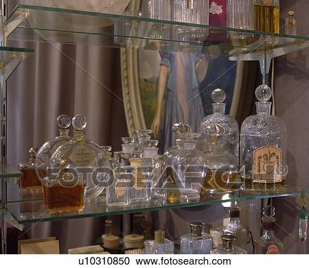 Stock Image - Close-up of collection of old French perfume bottles. Fotosearch