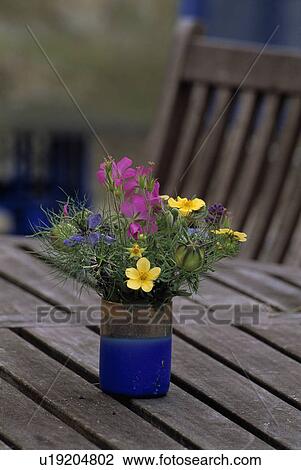 Close-up of colourful flowers in vase on bench View Large Photo Image Stock Image - Close-up of colourful flowers in vase on bench. Fotosearch