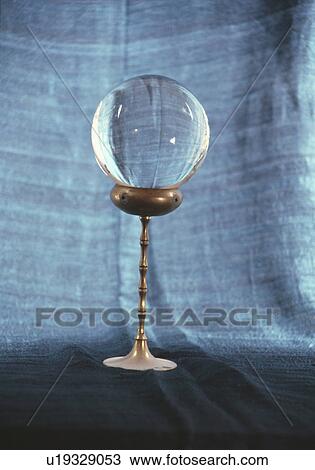 Stock Image - Close up of crystal ball on metal stand. Fotosearch