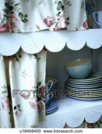 Close-up of floral curtains above shelves with scalloped paper edging View Large Photo Image Stock Image - Close-up of floral curtains above shelves with scalloped paper edging. Fotosearch