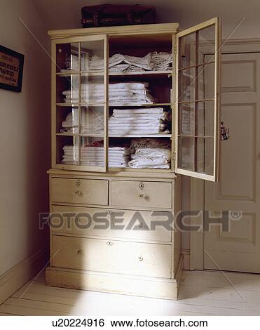 Stock Photograph - Close-up of glass-fronted linen press. Fotosearch