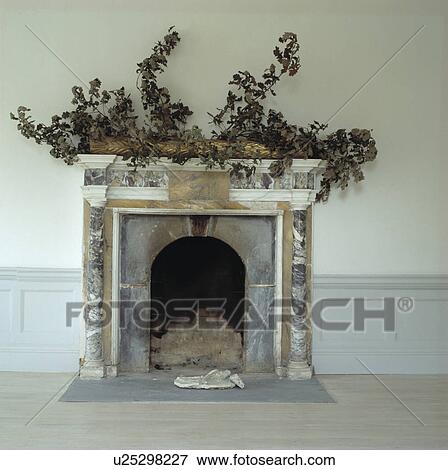Close-up of green branches on marble fireplace View Large Photo Image Stock Photo - Close-up of green branches on marble fireplace. Fotosearch
