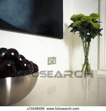 Close up of green chrysanthemums in glass vase on kitchen worktop View Large Photo Image Picture - Close up of green chrysanthemums in glass vase on kitchen worktop. Fotosearch