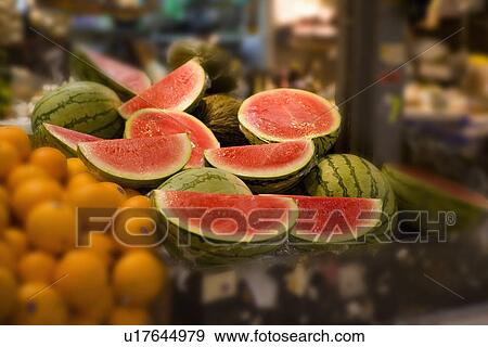 Close up of halved watermelons on Spanish market stall View Large Photo Image Stock Photo - Close up of halved watermelons on Spanish market stall. Fotosearch