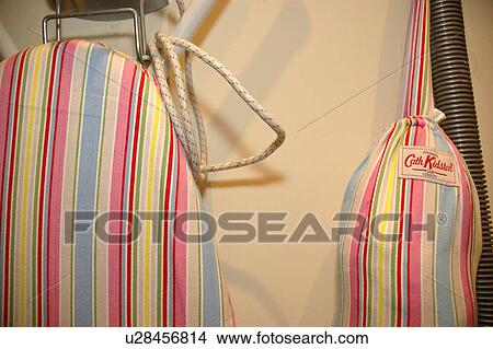 Close up of ironing board with pastel striped Cath Kidston cover and bag View Large Photo Image Picture - Close up of ironing board with pastel striped Cath Kidston cover and bag. Fotosearch