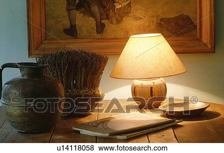 Close-up of lighted lamp and pottery jug on table View Large Photo Image Stock Photo - Close-up of lighted lamp and pottery jug on table. Fotosearch