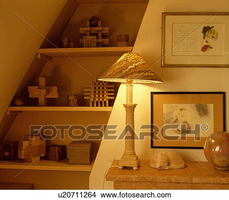Close-up of lighted lamp beside attic wall shelvdes View Large Photo Image Picture - Close-up of lighted lamp beside attic wall shelvdes. Fotosearch