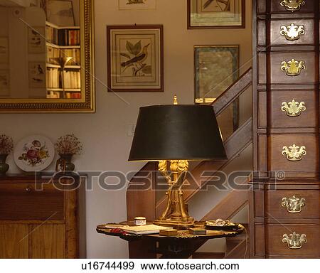 Stock Photo - Close-up of lighted lamp on small table. Fotosearch