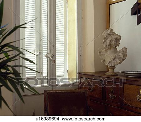 Close-up of marble bust in front of French windows View Large Photo Image Picture - Close-up of marble bust in front of French windows. Fotosearch