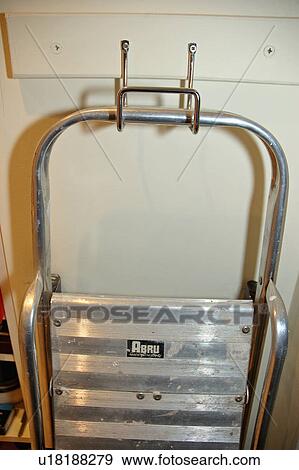 Close up of metal stepladder stored on hook View Large Photo Image Stock Photo - Close up of metal stepladder stored on hook. Fotosearch