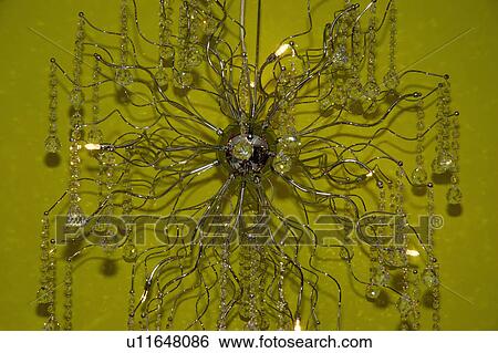 Close-up of modern branched chandelier against green background View Large Photo Image Stock Photograph - Close-up of modern branched chandelier against green background. Fotosearch