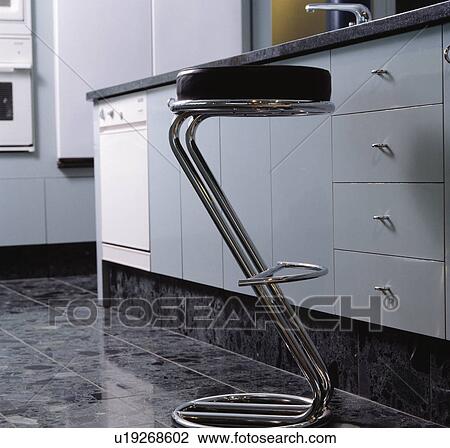 Stock Image - Close-up of modern leather and chrome bar-stool. Fotosearch
