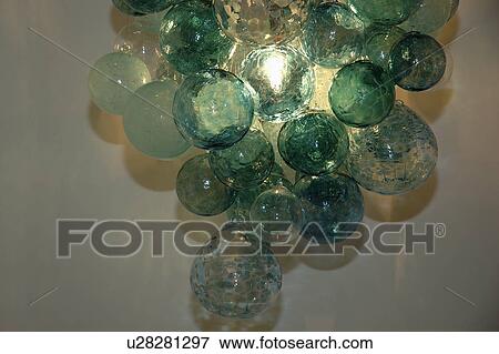 Close-up of modern light fitting of green glass baubles View Large Photo Image Stock Photo - Close-up of modern light fitting of green glass baubles. Fotosearch