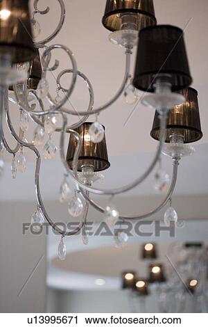 Close-up of modern stainless steel chandelier with brown lampshades and glass teardrops View Large Photo Image Stock Image - Close-up of modern stainless steel chandelier with brown lampshades and glass teardrops. Fotosearch