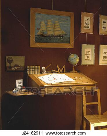 Stock Image - Close-up of nautical picture above pine writing slope. Fotosearch