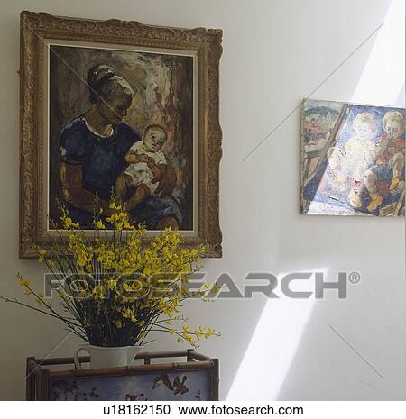 Stock Image - Close-up of oil portrait above yellow flowers in vase. Fotosearch
