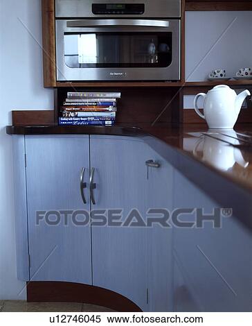 Close-up of oven above worktop with cookery books and white teapot View Large Photo Image Stock Photography - Close-up of oven above worktop with cookery books and white teapot. Fotosearch