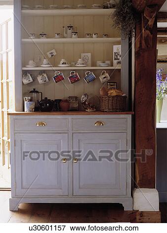 Stock Photo - Close-up of painted white wooden dresser in cottage kitchen. Fotosearch