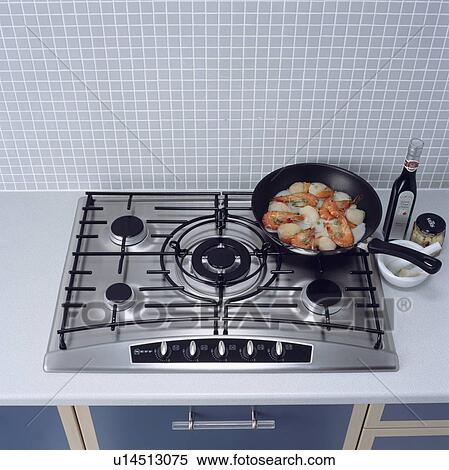 Close-up of pan with food on stainless steel gas hob View Large Photo Image Stock Photography - Close-up of pan with food on stainless steel gas hob . Fotosearch