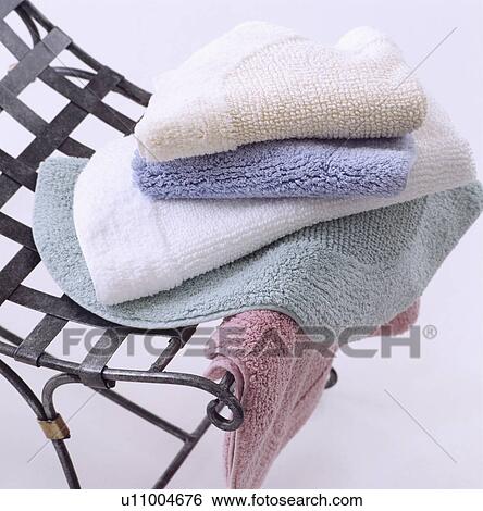 Close-up of pastel towelling bathmats on metal chair View Large Photo Image Stock Photograph - Close-up of pastel towelling bathmats on metal chair. Fotosearch
