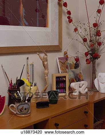 Stock Image - Close-up of pens in cups on cupboard. Fotosearch