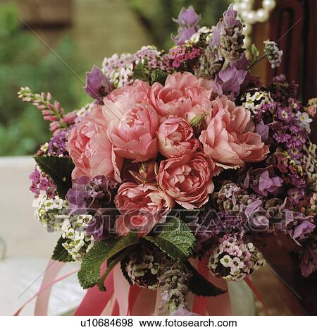 Close-up of pink paeonies in informal floral arrangement View Large Photo Image Stock Photo - Close-up of pink paeonies in informal floral arrangement. Fotosearch