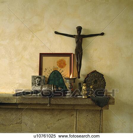 Close-up of pioture and religious artefacts on stone mantelpiece View Large Photo Image Stock Photography - Close-up of pioture and religious artefacts on stone mantelpiece. Fotosearch