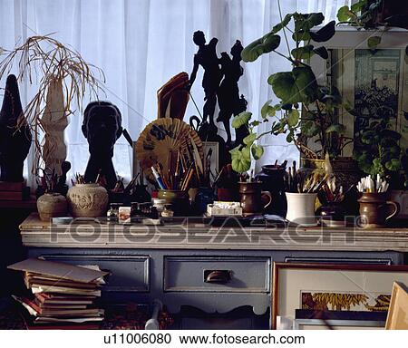 Stock Image - Close-up of pots of pens and pencils on dresser. Fotosearch