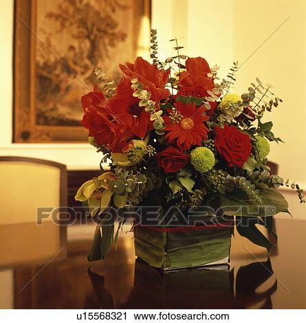 Stock Image - Close-up of red and green dahlias in floral arrangement. Fotosearch