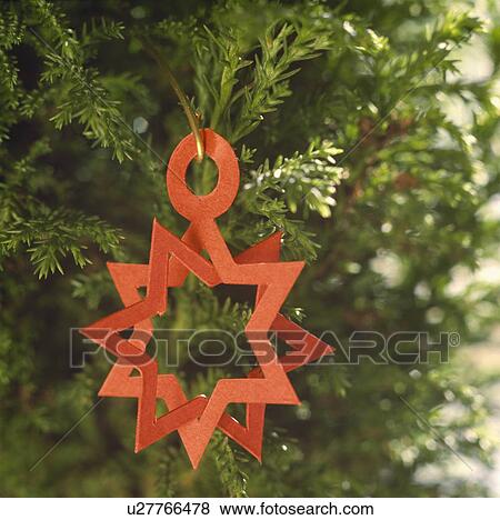 Close-up of red paper star on Christmas tree View Large Photo Image Stock Photo - Close-up of red paper star on Christmas tree. Fotosearch