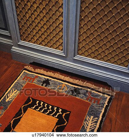 Picture - Close-up of rug below radiator cover. Fotosearch