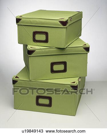 Stock Image - Close-up of set of green calico storage boxes . Fotosearch