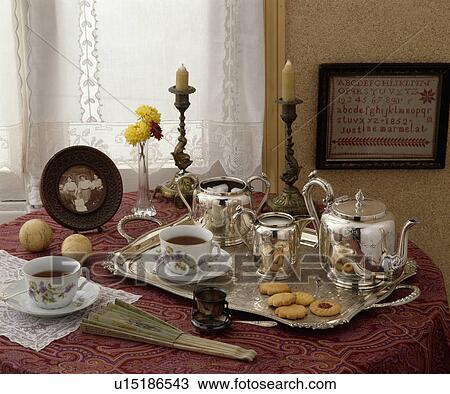 Close-up of silver teaset on silver tray with china cups and Victorian photograph on table View Large Photo Image Stock Image - Close-up of silver teaset on silver tray with china cups and Victorian photograph on table. Fotosearch