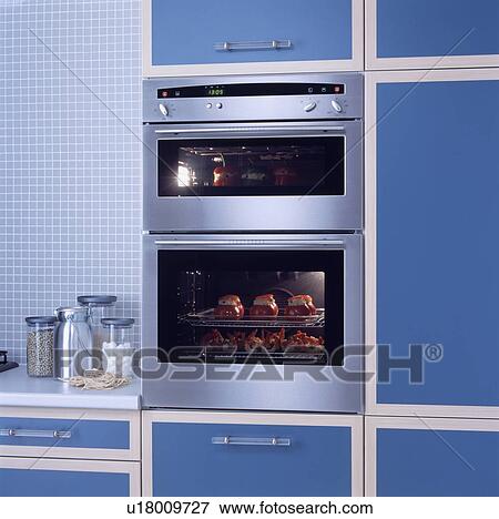 Stock Photo - Close-up of stainless steel double oven in modern blue kitchen unit&#13; &#10; &#13; &#10; &#13; &#10; &#13; &#10; &#13; &#10; &#13; &#10;. Fotosearch
