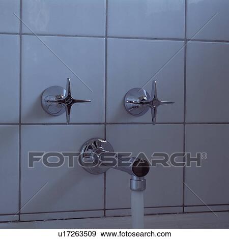 Close-up of stainless steel tap and controls on white tiles View Large Photo Image Stock Photo - Close-up of stainless steel tap and controls on white tiles. Fotosearch