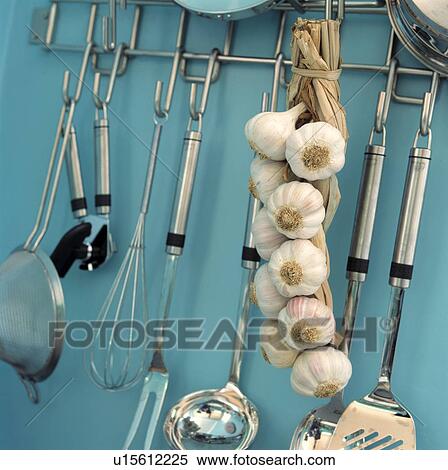 Close-up of string of garlic and stainless steel kitchen utensils stored on steel rack View Large Photo Image Stock Photography - Close-up of string of garlic and stainless steel kitchen utensils stored on steel rack. Fotosearch