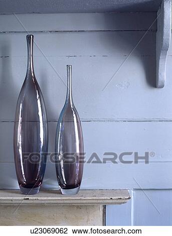 Stock Image - Close-up of tall modern glass vases. Fotosearch